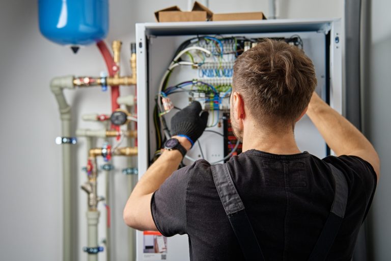 Electrician working at an electrical panel