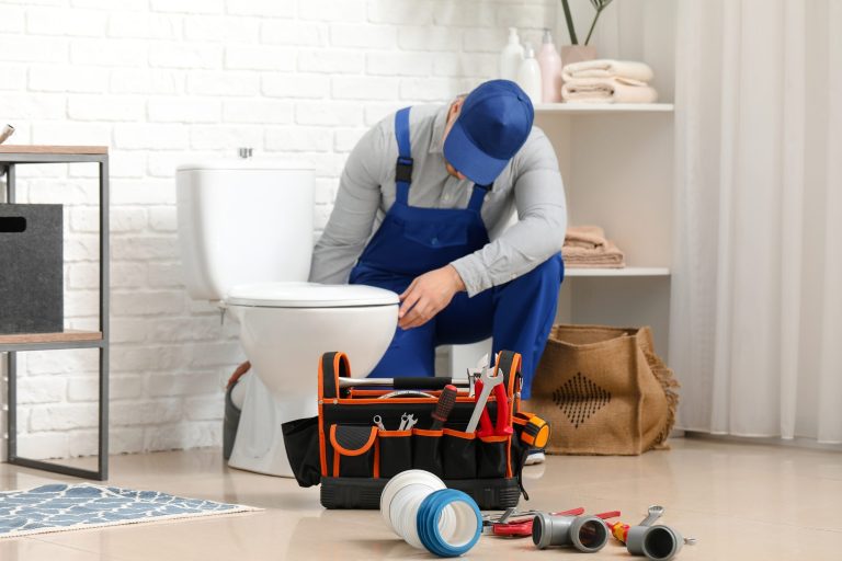 Plumber working on a toilet